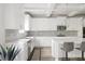 Clean, modern kitchen featuring white cabinets, light gray backsplash, and island with seating at 2622 Running River Ct, Lawrenceville, GA 30045