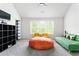 Spacious living room with a large window, colorful seating, and modern decor at 2622 Running River Ct, Lawrenceville, GA 30045
