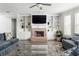 Open living room with brick fireplace, built-in shelving and plenty of natural light at 2622 Running River Ct, Lawrenceville, GA 30045