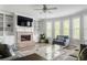 Cozy living room with brick fireplace, built-in shelving, large windows, and comfortable seating at 2622 Running River Ct, Lawrenceville, GA 30045