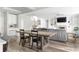 Open concept living area with brick fireplace, built-in cabinets, and view of the dining area and staircase at 2622 Running River Ct, Lawrenceville, GA 30045