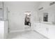 Bright main bathroom with double vanity, glass enclosed shower, and walk-in closet at 2622 Running River Ct, Lawrenceville, GA 30045