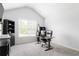 Office with vaulted ceiling features a large window providing natural light, and a modern desk setup at 2622 Running River Ct, Lawrenceville, GA 30045