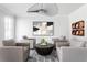Bright and modern sitting room with unique ceiling fan and hardwood flooring at 2622 Running River Ct, Lawrenceville, GA 30045