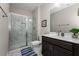 Stylish bathroom with a glass-enclosed shower, marble vanity, dark wood cabinets, and neutral paint at 380 Parkside Meadow Dr, Marietta, GA 30064