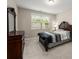 Comfortable bedroom with neutral paint, carpet flooring, a wooden bed frame, and a window at 380 Parkside Meadow Dr, Marietta, GA 30064