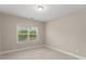 Empty room with neutral paint, carpet flooring, one window, and natural light at 380 Parkside Meadow Dr, Marietta, GA 30064