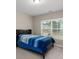 Neutral bedroom with a single bed and a view of the outdoors, creating a cozy and inviting space at 380 Parkside Meadow Dr, Marietta, GA 30064