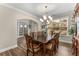 Elegant dining room with dark wood furniture, chandelier, and natural light at 380 Parkside Meadow Dr, Marietta, GA 30064