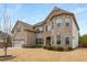 Inviting two-story home with a brick facade, well-maintained lawn, and an attached two-car garage at 380 Parkside Meadow Dr, Marietta, GA 30064