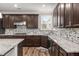 Gourmet kitchen featuring stainless steel appliances, granite countertops, and custom cabinetry at 380 Parkside Meadow Dr, Marietta, GA 30064