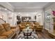 Spacious living room with hardwood floors, comfortable seating, and an open layout to the kitchen at 380 Parkside Meadow Dr, Marietta, GA 30064