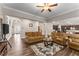 Open-concept living room flowing into the kitchen, featuring hardwood floors and comfortable seating at 380 Parkside Meadow Dr, Marietta, GA 30064