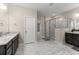 Elegant main bathroom with double vanities, granite countertops, glass-enclosed shower, and marble floors at 380 Parkside Meadow Dr, Marietta, GA 30064