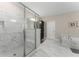 Luxurious main bathroom featuring a glass enclosed shower, soaking tub and marble tile flooring at 380 Parkside Meadow Dr, Marietta, GA 30064