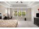 Spacious main bedroom featuring tray ceilings, neutral paint, and bright, natural light from multiple windows at 380 Parkside Meadow Dr, Marietta, GA 30064
