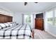 Comfortable bedroom featuring a queen-sized bed, a dresser, and large windows with views at 1621 Dixie Rd, Covington, GA 30014