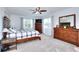 Spacious bedroom with ample natural light, neutral carpet, and classic wood furniture at 1621 Dixie Rd, Covington, GA 30014
