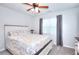 Bright bedroom with a ceiling fan, neutral walls, and a cozy bed and bedding at 1621 Dixie Rd, Covington, GA 30014