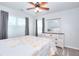 Bedroom featuring a dresser, a ceiling fan, two windows and neutral carpeting at 1621 Dixie Rd, Covington, GA 30014