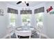 Cozy breakfast nook with large windows, a round table, and stylish black and white decor at 1621 Dixie Rd, Covington, GA 30014