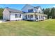 Well-manicured front lawn and exterior of white farmhouse with black trim at 1621 Dixie Rd, Covington, GA 30014