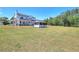 Angle shot of white farmhouse with gazebo and large front yard at 1621 Dixie Rd, Covington, GA 30014