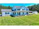 Beautiful two-story home with a large manicured lawn and a charming covered front porch at 1621 Dixie Rd, Covington, GA 30014