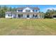 Exterior shot of white farmhouse with long porch and large front yard at 1621 Dixie Rd, Covington, GA 30014