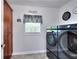 Convenient laundry room with modern appliances and ample storage cabinets at 1621 Dixie Rd, Covington, GA 30014