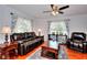 Comfortable living room with hardwood floors, plush leather furniture, and plenty of natural light at 1621 Dixie Rd, Covington, GA 30014