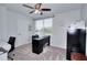 Well-lit home office featuring desk space, comfortable seating, and abundant natural light at 1621 Dixie Rd, Covington, GA 30014