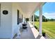 Inviting covered front porch with seating area, perfect for relaxing and enjoying the outdoors at 1621 Dixie Rd, Covington, GA 30014
