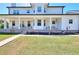 Long covered porch with white columns, chairs and small tables at 1621 Dixie Rd, Covington, GA 30014