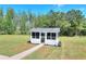 Relaxing screened porch, perfect for outdoor enjoyment with views of the surrounding greenery at 1621 Dixie Rd, Covington, GA 30014