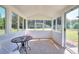Bright screened porch with a small table, seating, and view to backyard at 1621 Dixie Rd, Covington, GA 30014