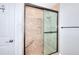 Shower with tan-colored tile and a built-in bench and shower caddy at 1621 Dixie Rd, Covington, GA 30014