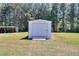 Backyard view of a storage shed with ample space and a large grassy area at 1621 Dixie Rd, Covington, GA 30014