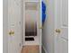 Hallway view to bathroom featuring neutral tile and white shower curtain at 210 Cottonwood Creek Cir, Canton, GA 30114