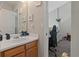 Bright bathroom view through doorway featuring white sink and cabinet and wall decor at 210 Cottonwood Creek Cir, Canton, GA 30114