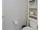 Neutral bathroom with a toilet, open storage shelf, and white toilet paper holder at 210 Cottonwood Creek Cir, Canton, GA 30114