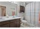 Clean bathroom with dual sinks, wood cabinets, and a shower/tub combo at 210 Cottonwood Creek Cir, Canton, GA 30114