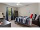 Bedroom with ceiling fan, blue curtains, bed, desk, and dresser at 210 Cottonwood Creek Cir, Canton, GA 30114