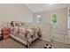 Cozy bedroom featuring a sports-themed quilt and plenty of natural light from two windows at 210 Cottonwood Creek Cir, Canton, GA 30114