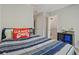 Bedroom with blue stripped bedding, and view to open door with safety gate at 210 Cottonwood Creek Cir, Canton, GA 30114