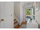 Bright entryway with hardwood floors, white console table, and a view of the outdoors at 210 Cottonwood Creek Cir, Canton, GA 30114