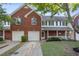 Charming townhome featuring brick facade, complemented by blue shutters and a well-manicured lawn at 210 Cottonwood Creek Cir, Canton, GA 30114