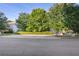 Pleasant home exterior with large trees and a well-maintained lawn, offering a serene and private setting at 210 Cottonwood Creek Cir, Canton, GA 30114