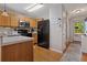 Well-organized kitchen featuring wood cabinetry, black appliances and an entry way for easy access at 210 Cottonwood Creek Cir, Canton, GA 30114