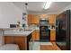 Cozy kitchen offering wood cabinets and black appliances, creating a functional cooking space at 210 Cottonwood Creek Cir, Canton, GA 30114